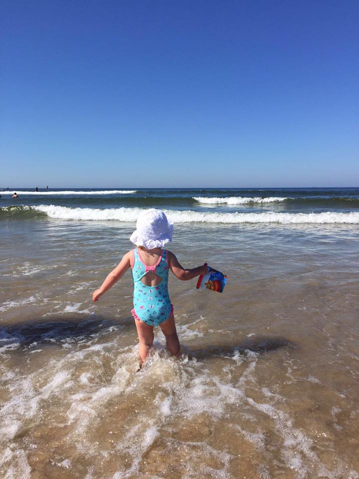 Beach in Porto with child playing in the sea