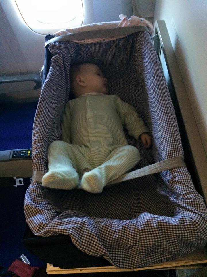 baby in basinet in plane