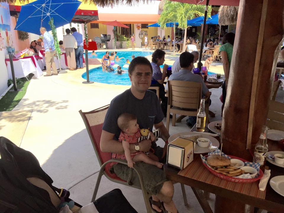 dad and baby having lunch by pool