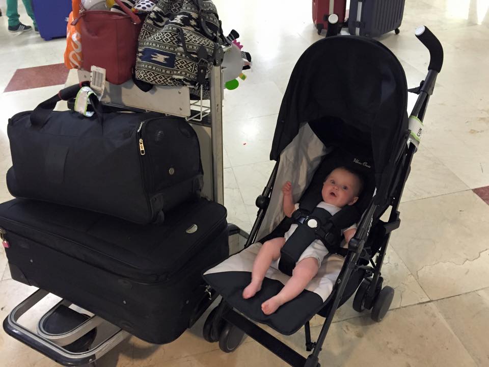 baby in airport with lots of bags