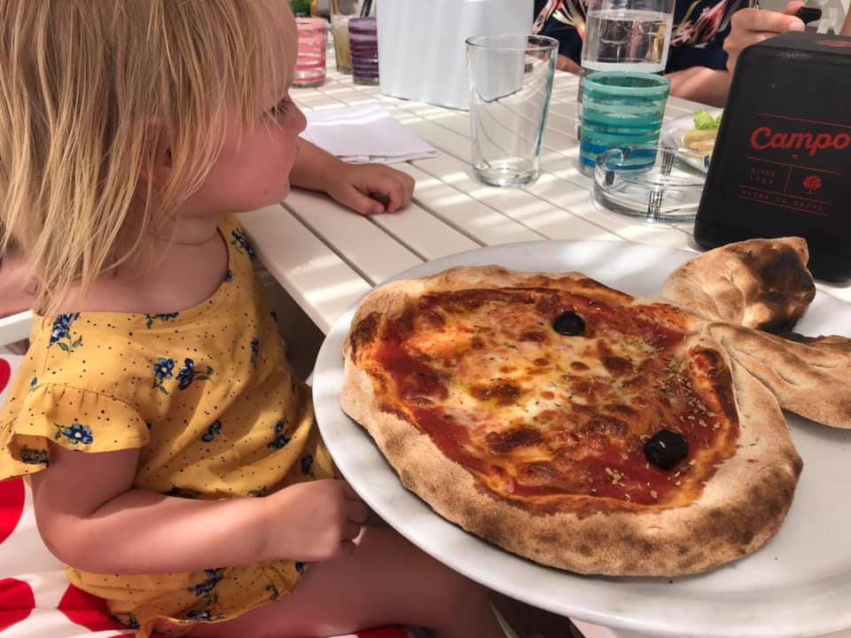 Child with rabbit shaped pizza when on holiday with our children 