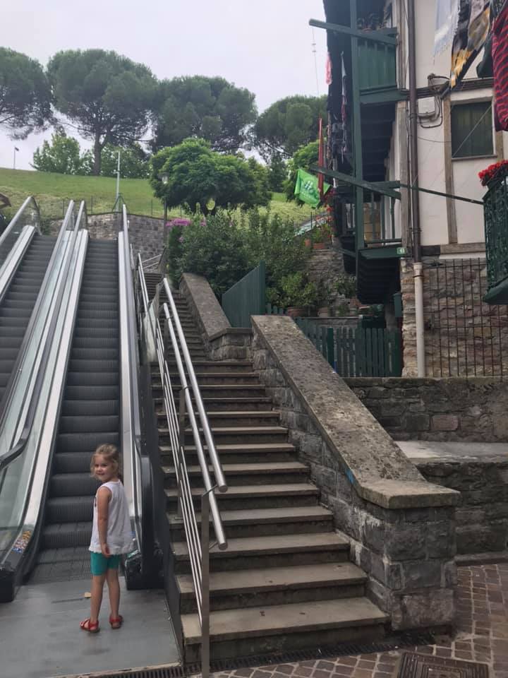 a girl standing by an escalator in Hondarribia