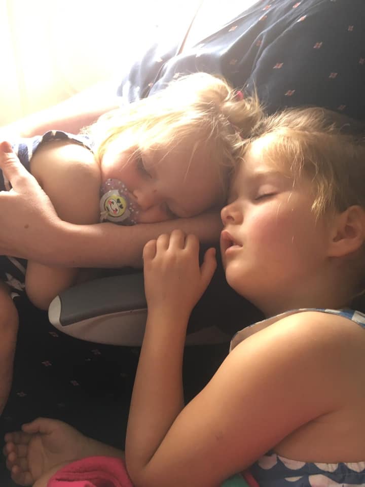 two girls sleeping on a plane