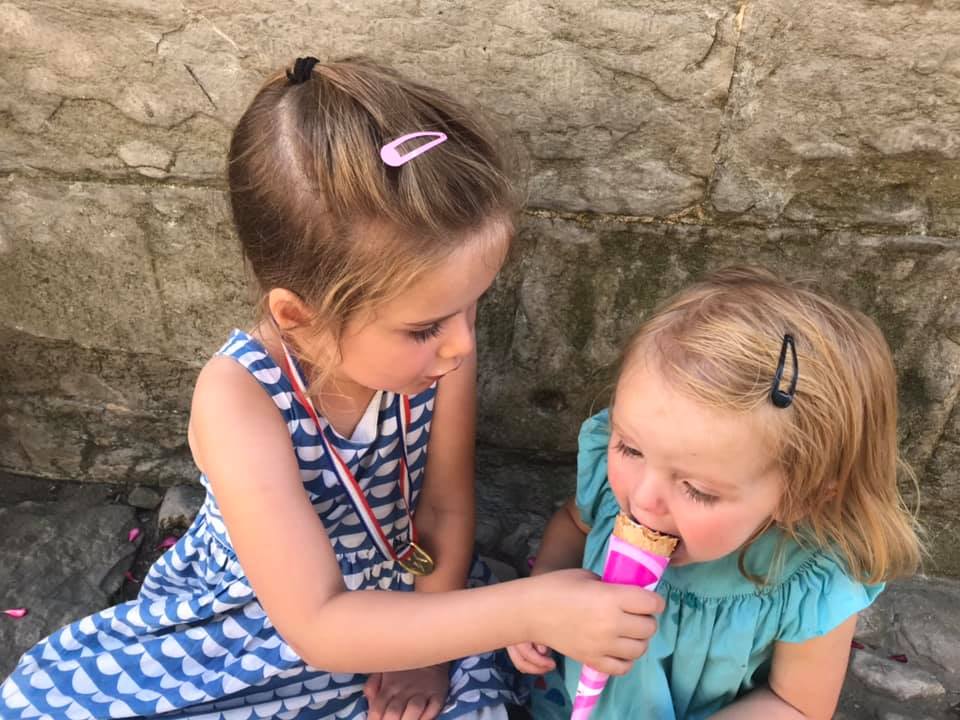 two girls sharing an ice cream 