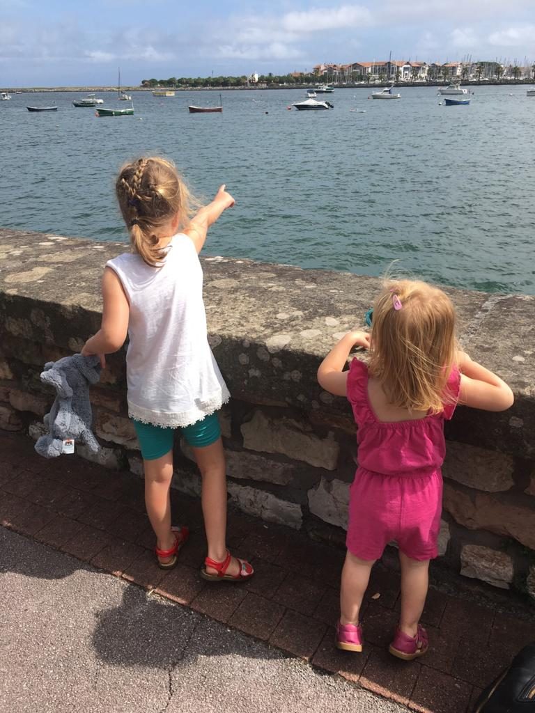 a girl and her sister looking at the border to france 