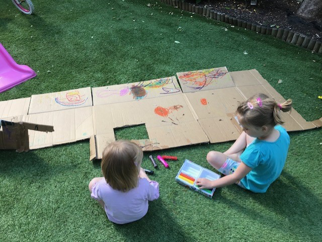 children painting in a garden