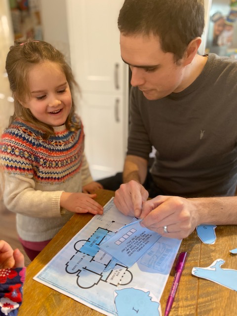 dad and daughter solving puzzle