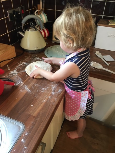 child cooking in kitchen