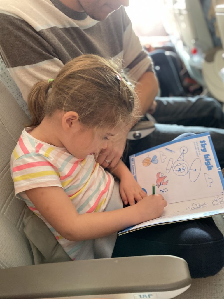 girl doing activities on plane