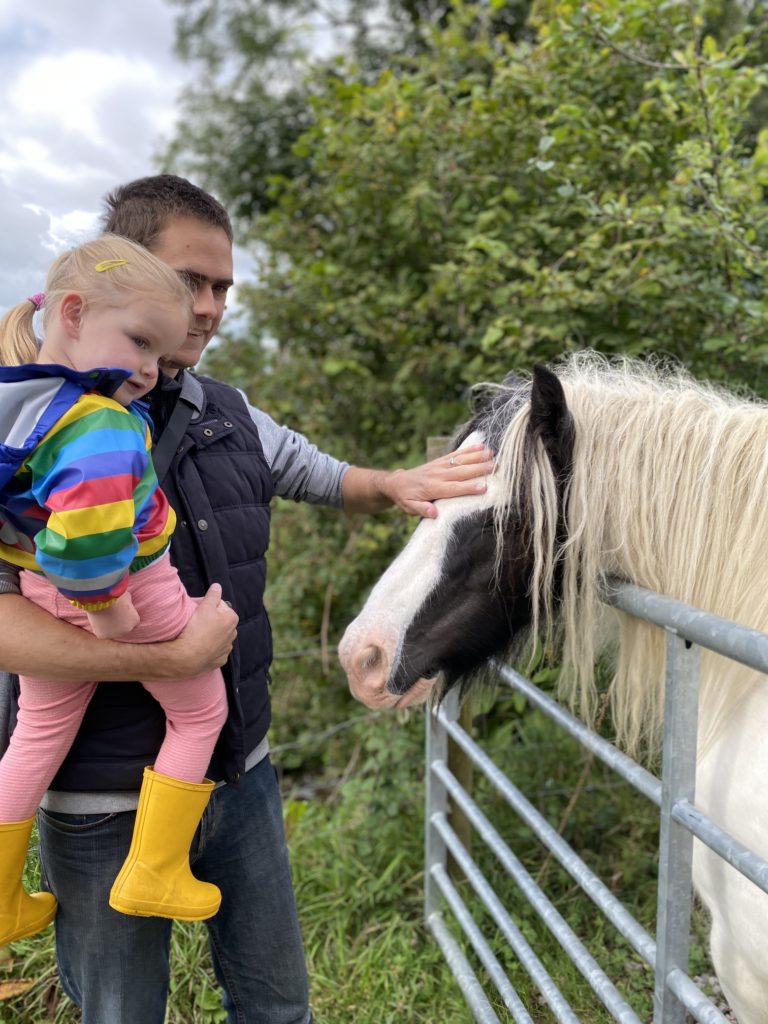 man and girl stroking a horse at Cwmberach Farm TRAVEL REVIEW - Glamping at Cwmberach Uchaf Farm with Feather Down