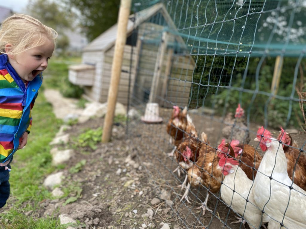 girl happy at chickens