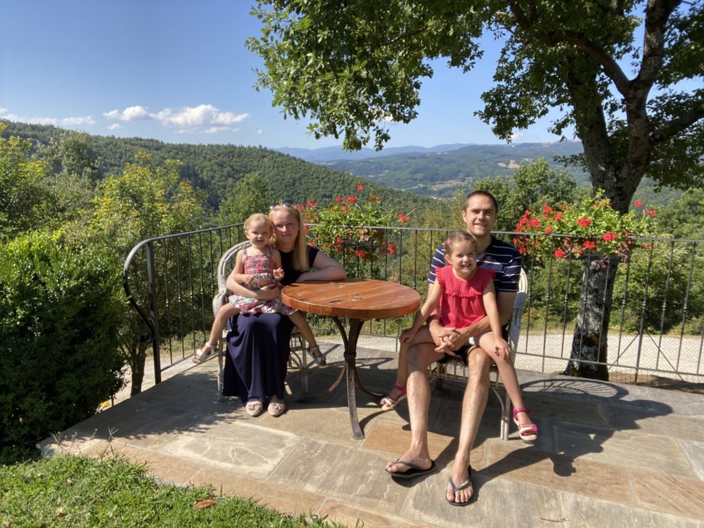 family in tuscany rolling hills 