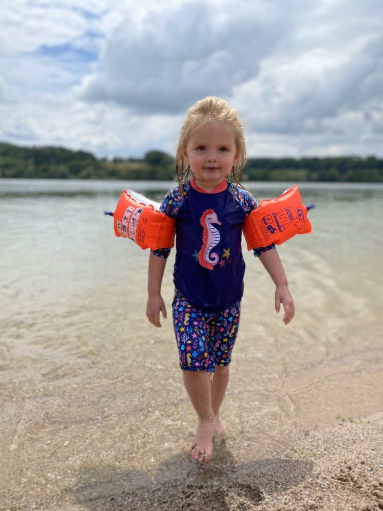 little girl coming out of water