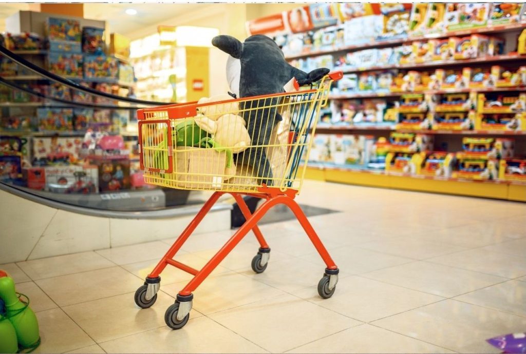 a shopping cart in front of toys. a great shop to visit in london with toddlers and children