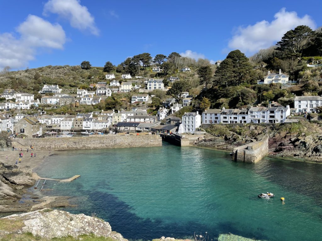 Polperro harbour from the headlands, blue water and cottages. 