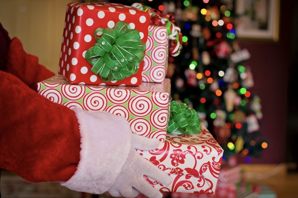 a stack of presents in santas hands 