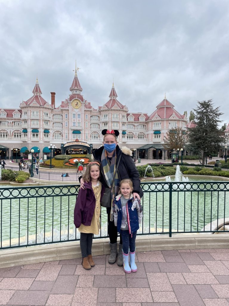 mum and daughters in from of Disneyland Paris hotel 