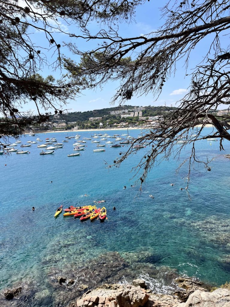 view of clear blue water and kayaks bobbing in the sea 