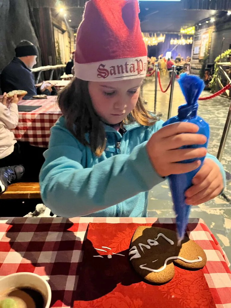 child decorating a cookie in santa park lapland 